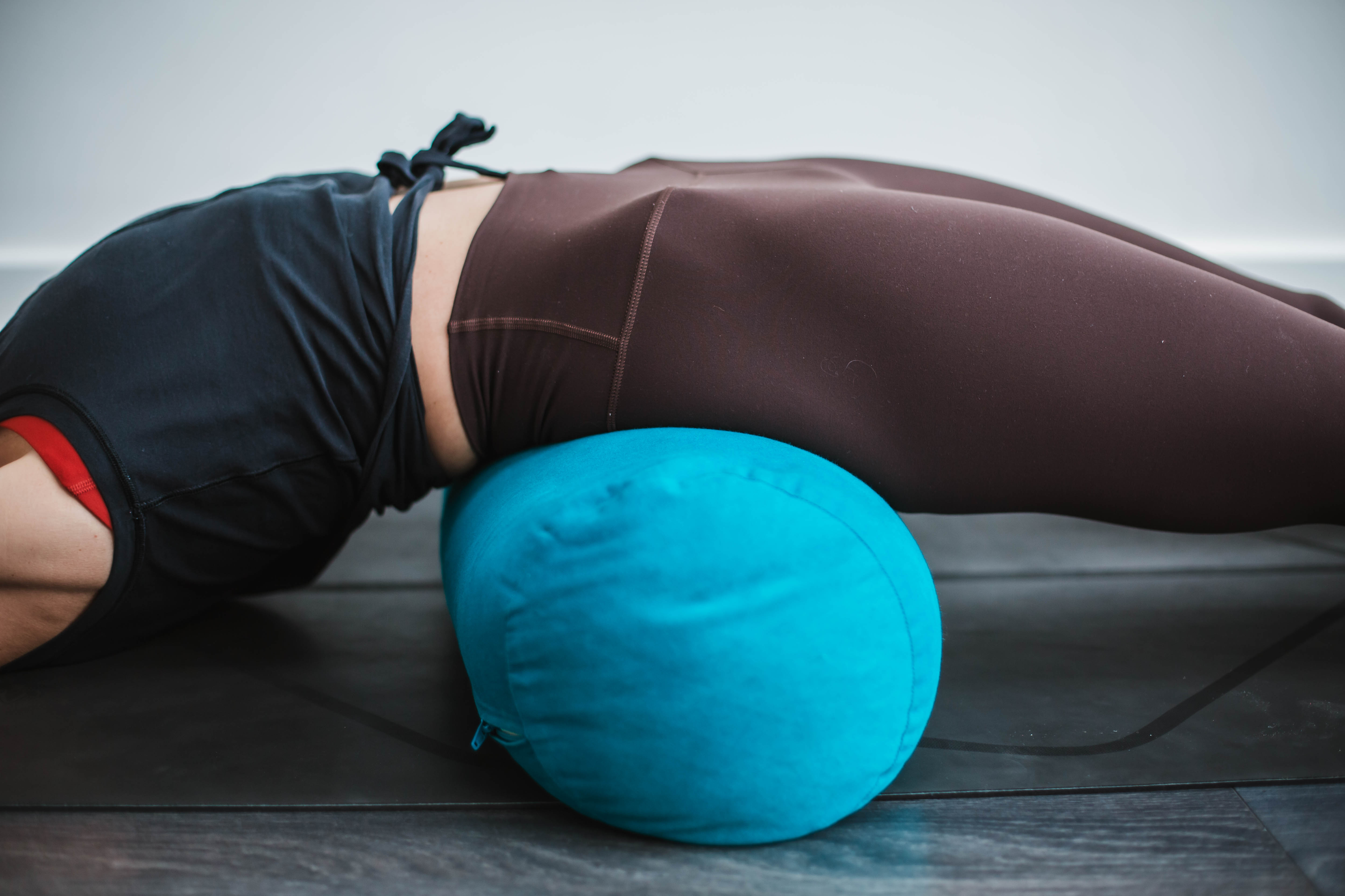 A quiet restorative yoga setup with bolster and blankets