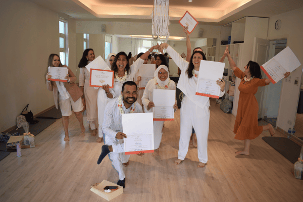 A Yogihearts training group celebrating with their certificates